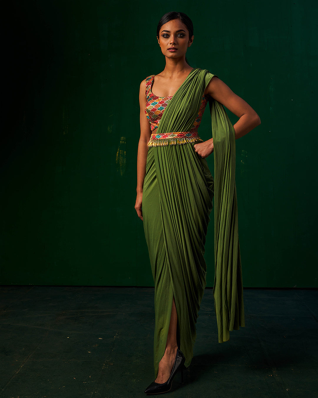 Model wearing Misakee designer green drape Indowestern saree with pleated silhouette and embroidered blouse - perfect for weddings, cocktail parties, and festive wear.